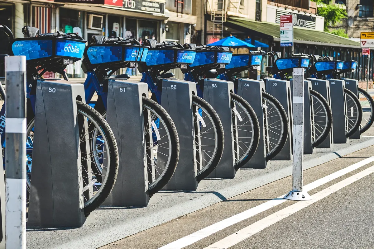 Row of Citi Bikes parked at a docking station in New York City, ready for public use.