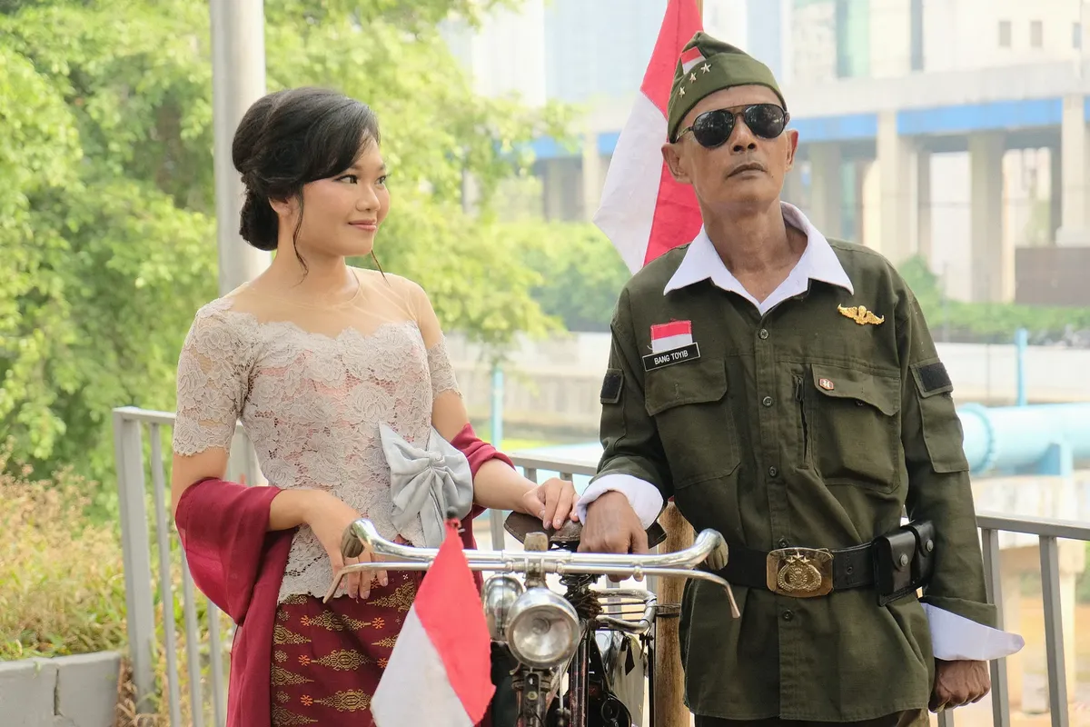 Traditional attire and vintage military uniform in Jakarta, showcasing Indonesian pride and heritage.